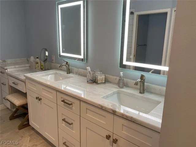 a bathroom with double sink and a mirror