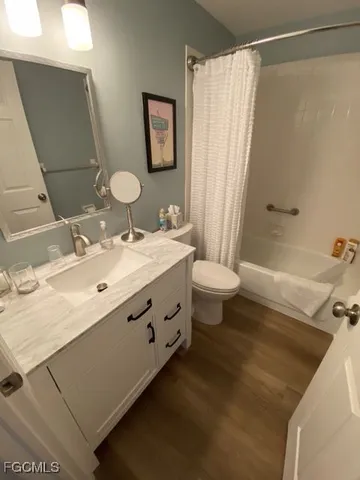 a bathroom with a double vanity sink toilet and shower