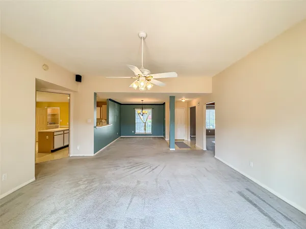 a view of an empty room with a fireplace and a window