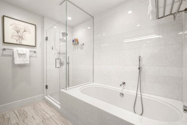 a bathroom with a tub a window and a shower