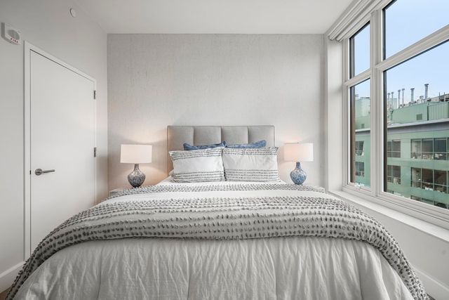 a bedroom with a bed and a night stand