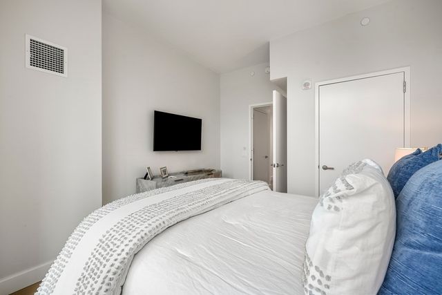 a bedroom with a bed and a flat screen tv