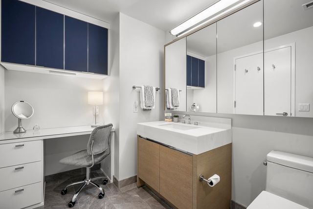 a kitchen with a sink cabinets and wooden floor