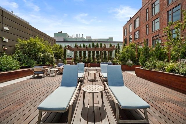 a view of yard from roof deck with patio