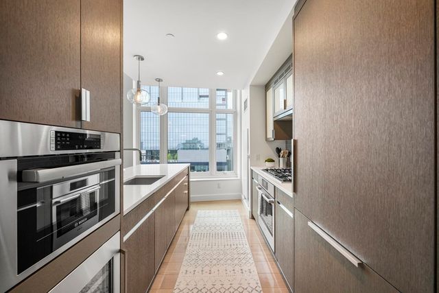 a kitchen with stainless steel appliances a sink and a stove