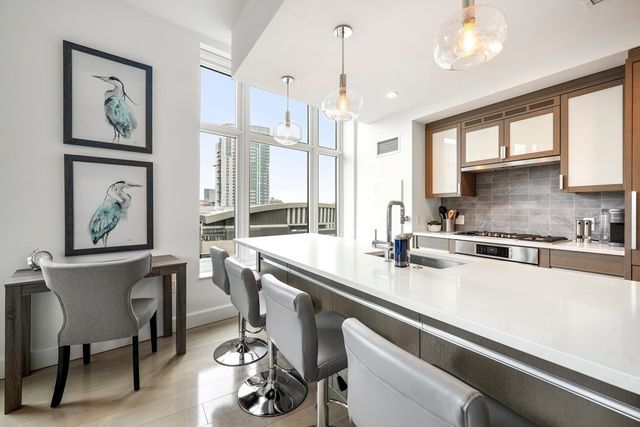 a kitchen with a sink appliances and a counter top space