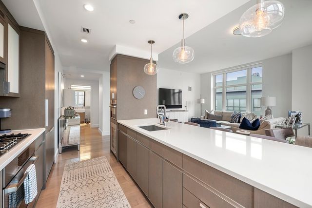a kitchen with a sink a counter and cabinets