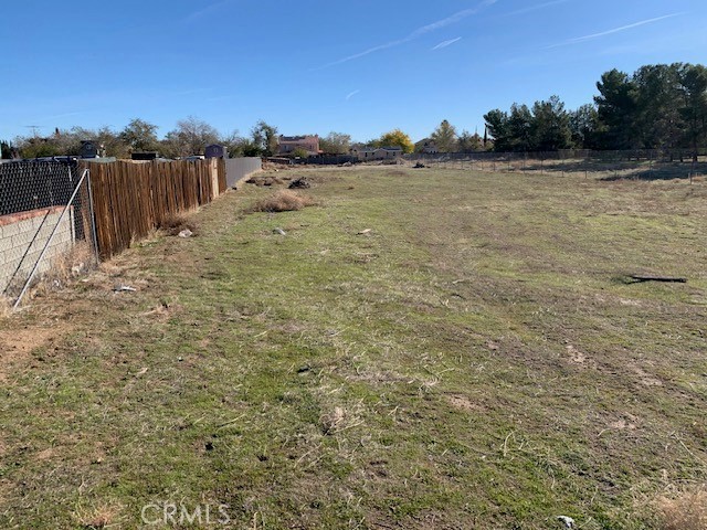 0 26th Street East Palmdale, CA 93550 - Photo 4 of 4 a view of a dry yard with wooden fence
