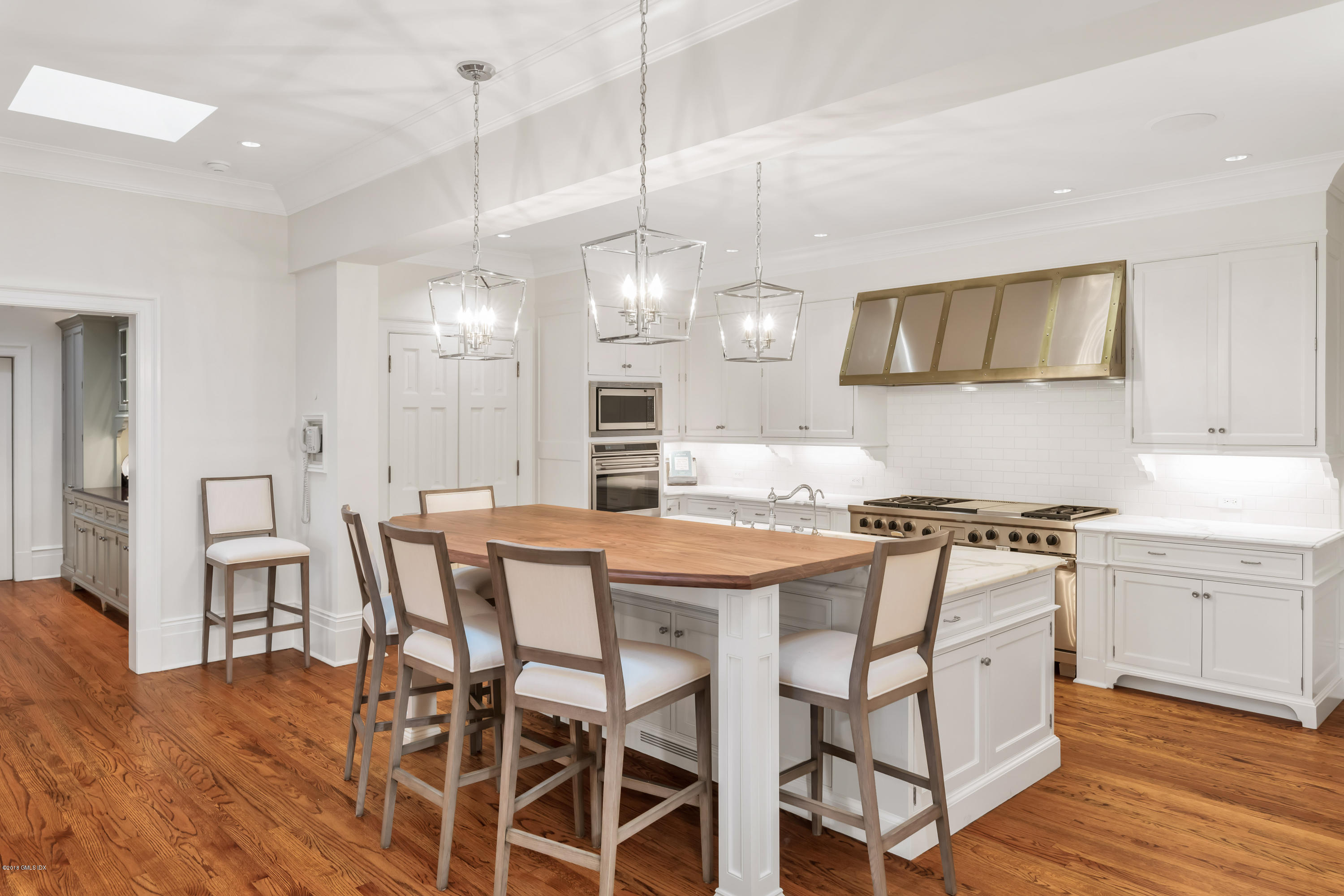 449 Round Hill Road Greenwich, CT 06831 - Photo 16 of 57 a kitchen with stainless steel appliances a stove a table and chairs in it