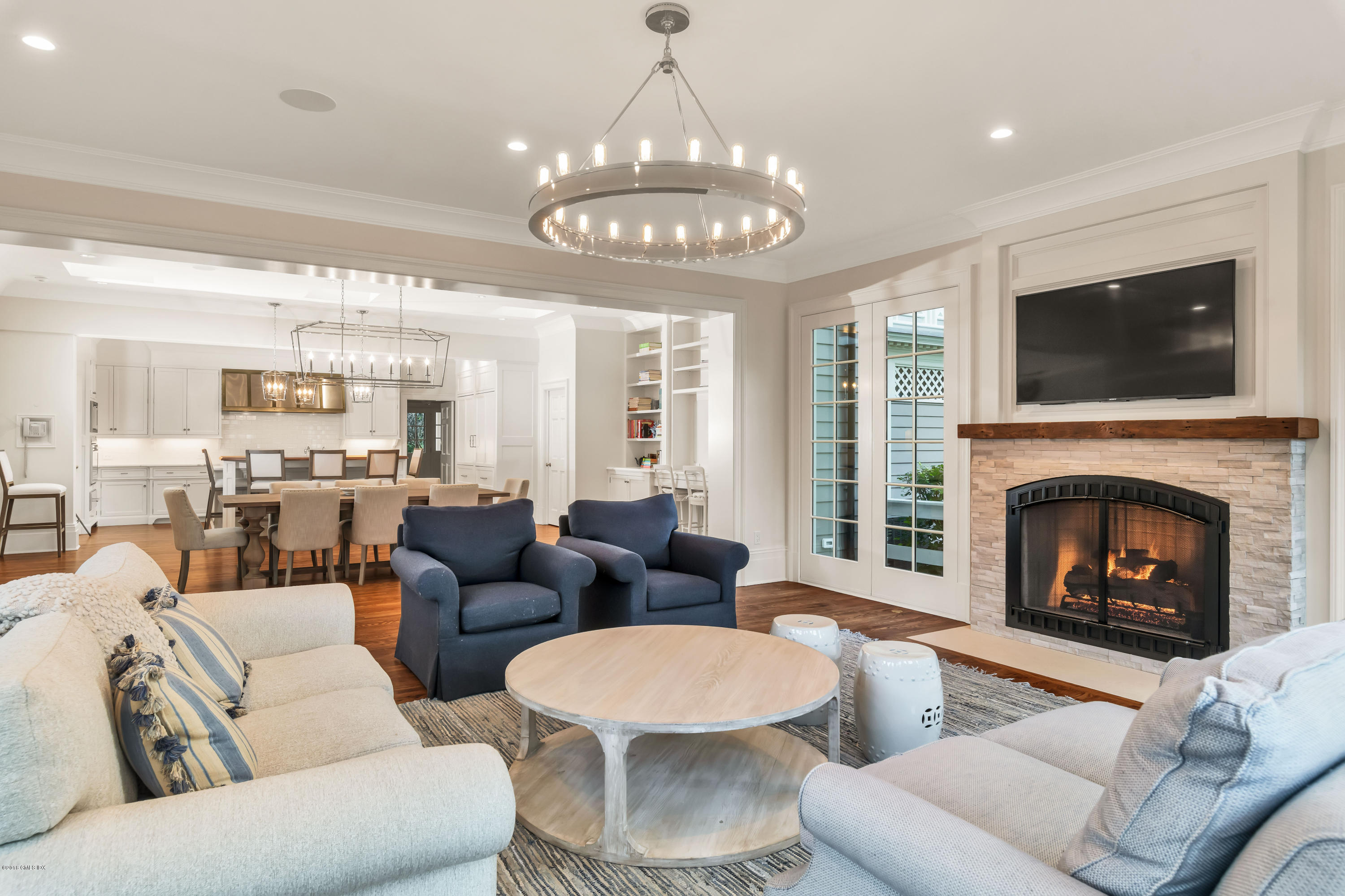 449 Round Hill Road Greenwich, CT 06831 - Photo 22 of 57 a living room with furniture a fireplace and a flat screen tv