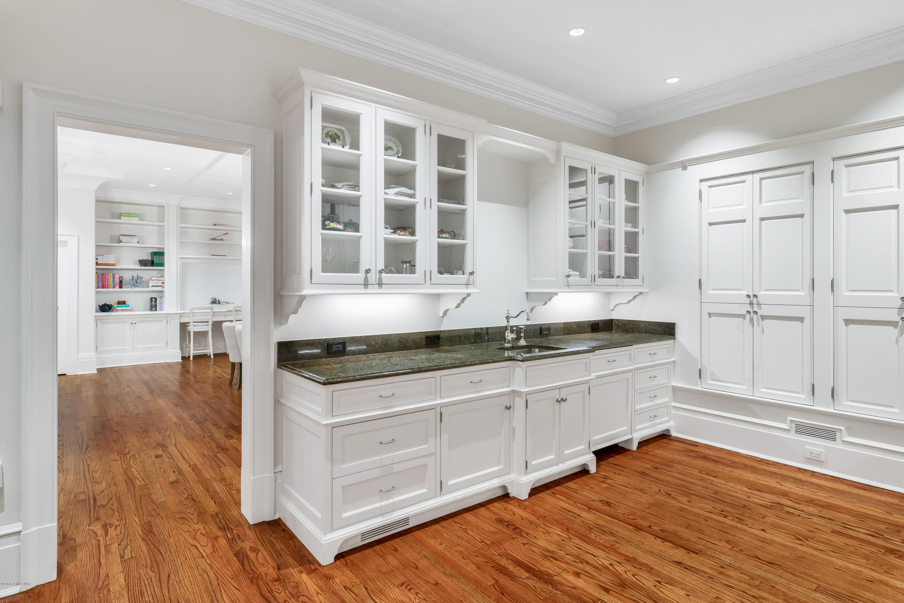 449 Round Hill Road Greenwich, CT 06831 - Photo 25 of 57 a kitchen with granite countertop white cabinets and white appliances