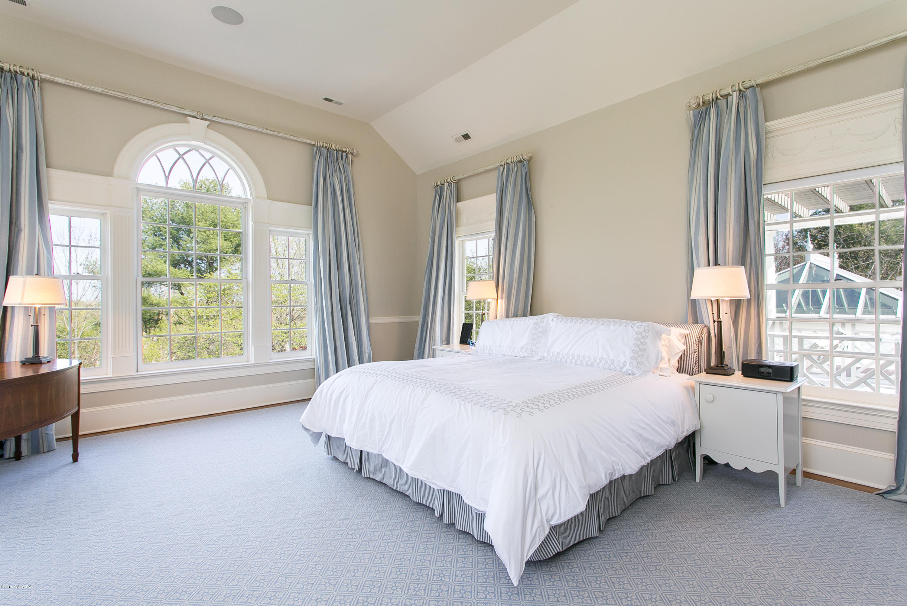 449 Round Hill Road Greenwich, CT 06831 - Photo 27 of 57 a bedroom with a bed and a large window