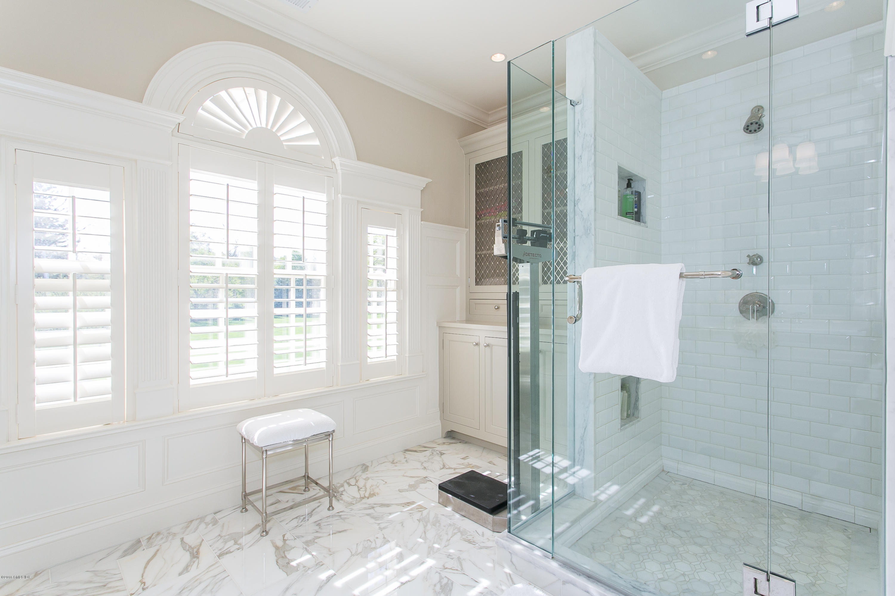 449 Round Hill Road Greenwich, CT 06831 - Photo 32 of 57 a spacious bathroom with a granite countertop shower a sink and a mirror