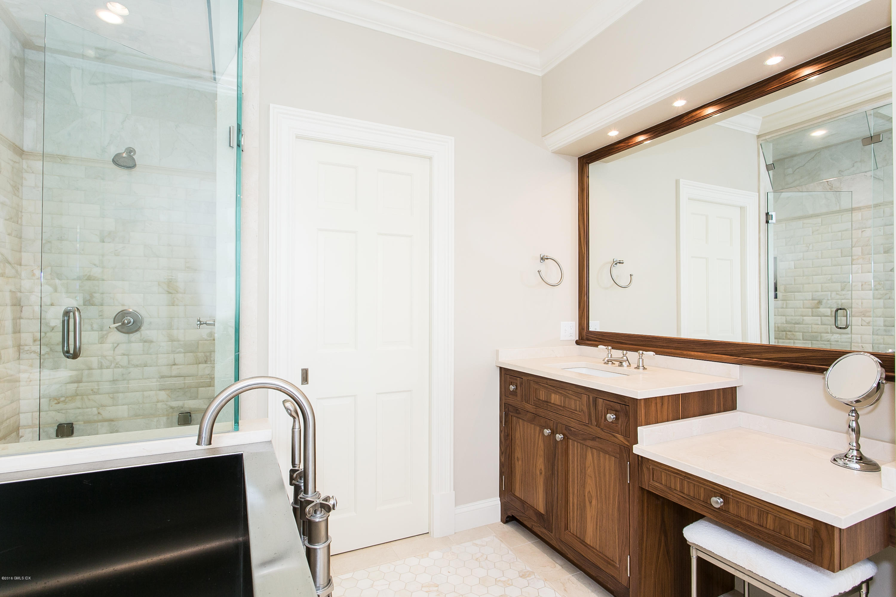 449 Round Hill Road Greenwich, CT 06831 - Photo 33 of 57 a bathroom with a double vanity sink a toilet a mirror and shower