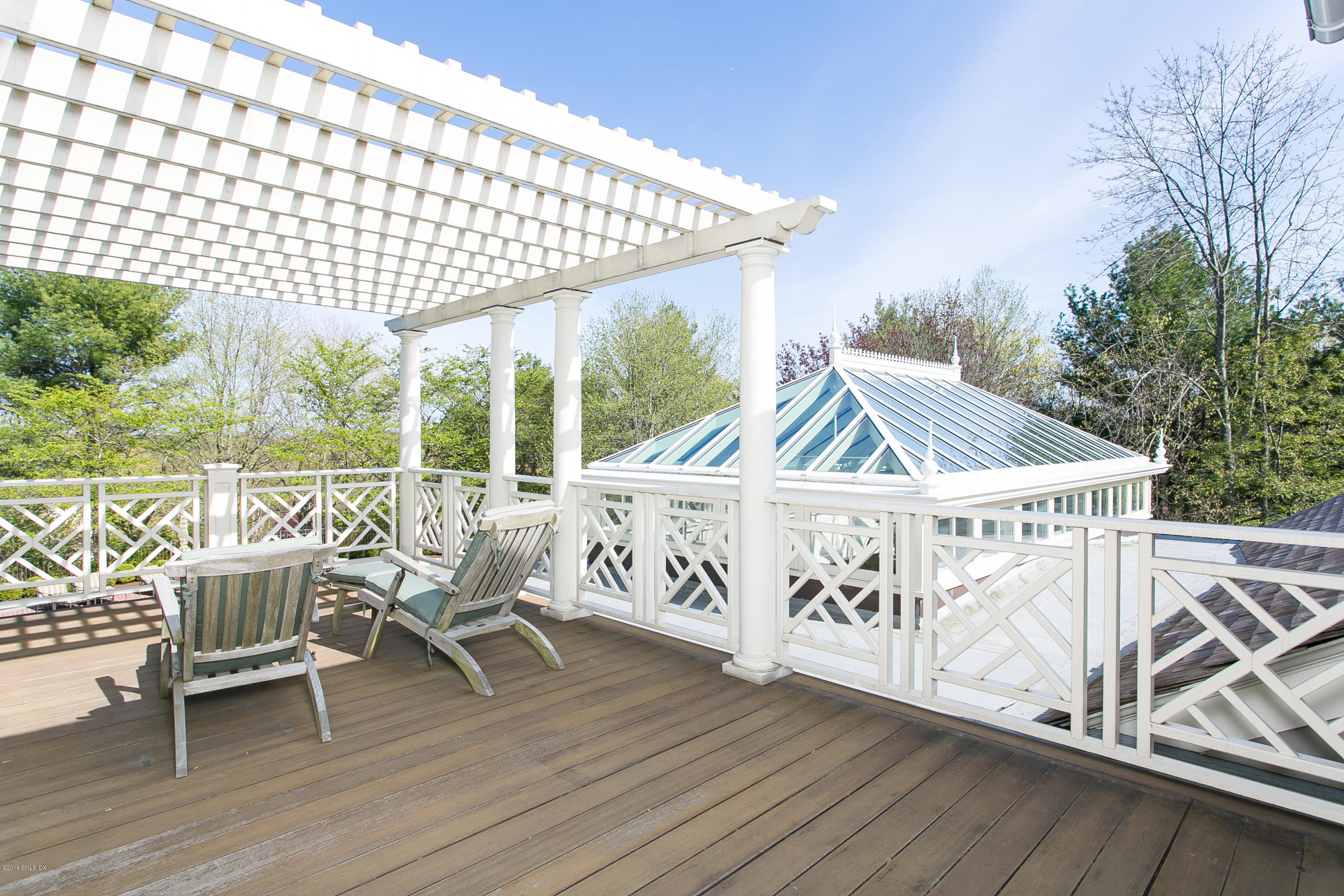 449 Round Hill Road Greenwich, CT 06831 - Photo 35 of 57 a view of a chairs and table on the wooden deck