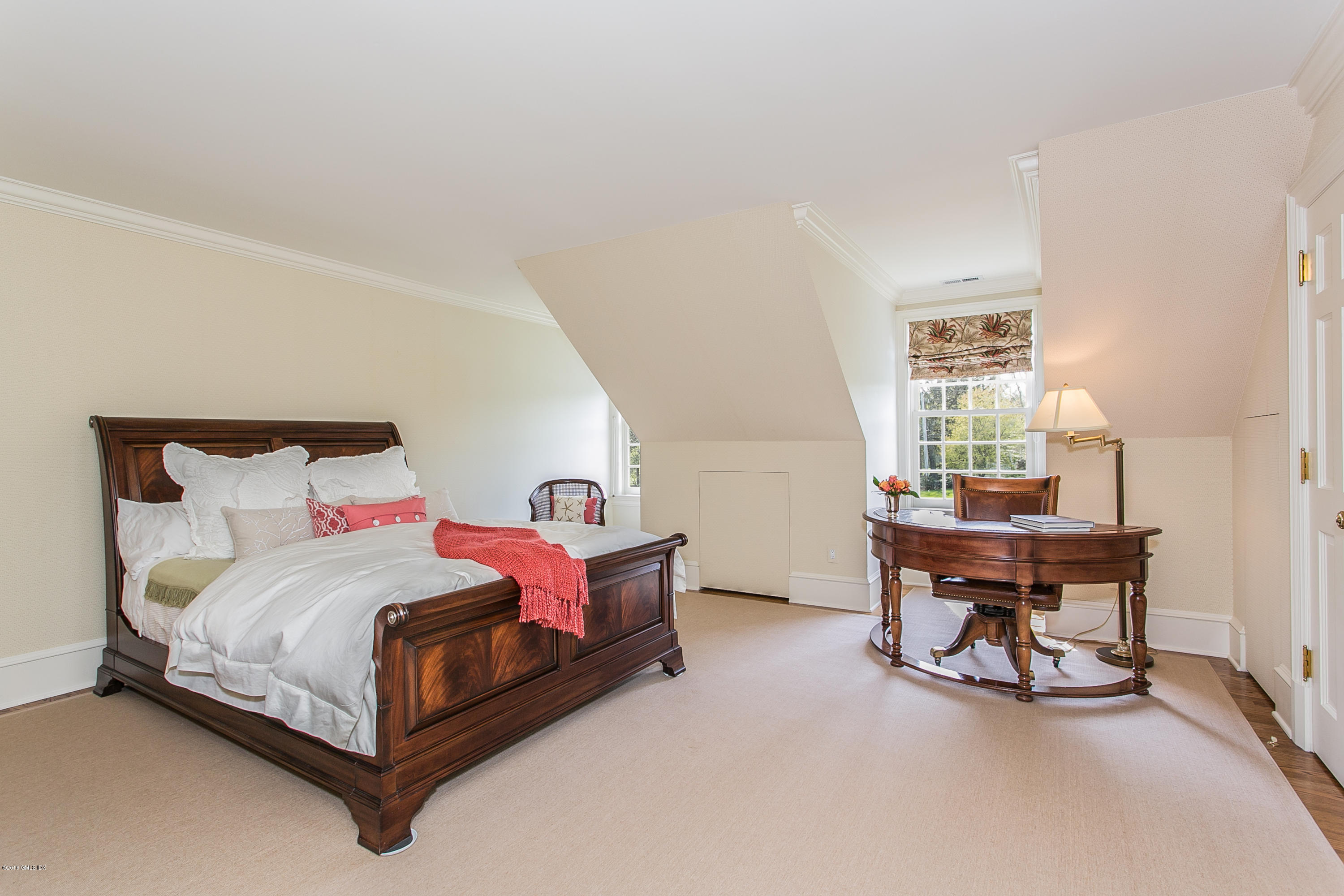 449 Round Hill Road Greenwich, CT 06831 - Photo 38 of 57 a bedroom with a bed and a table in it