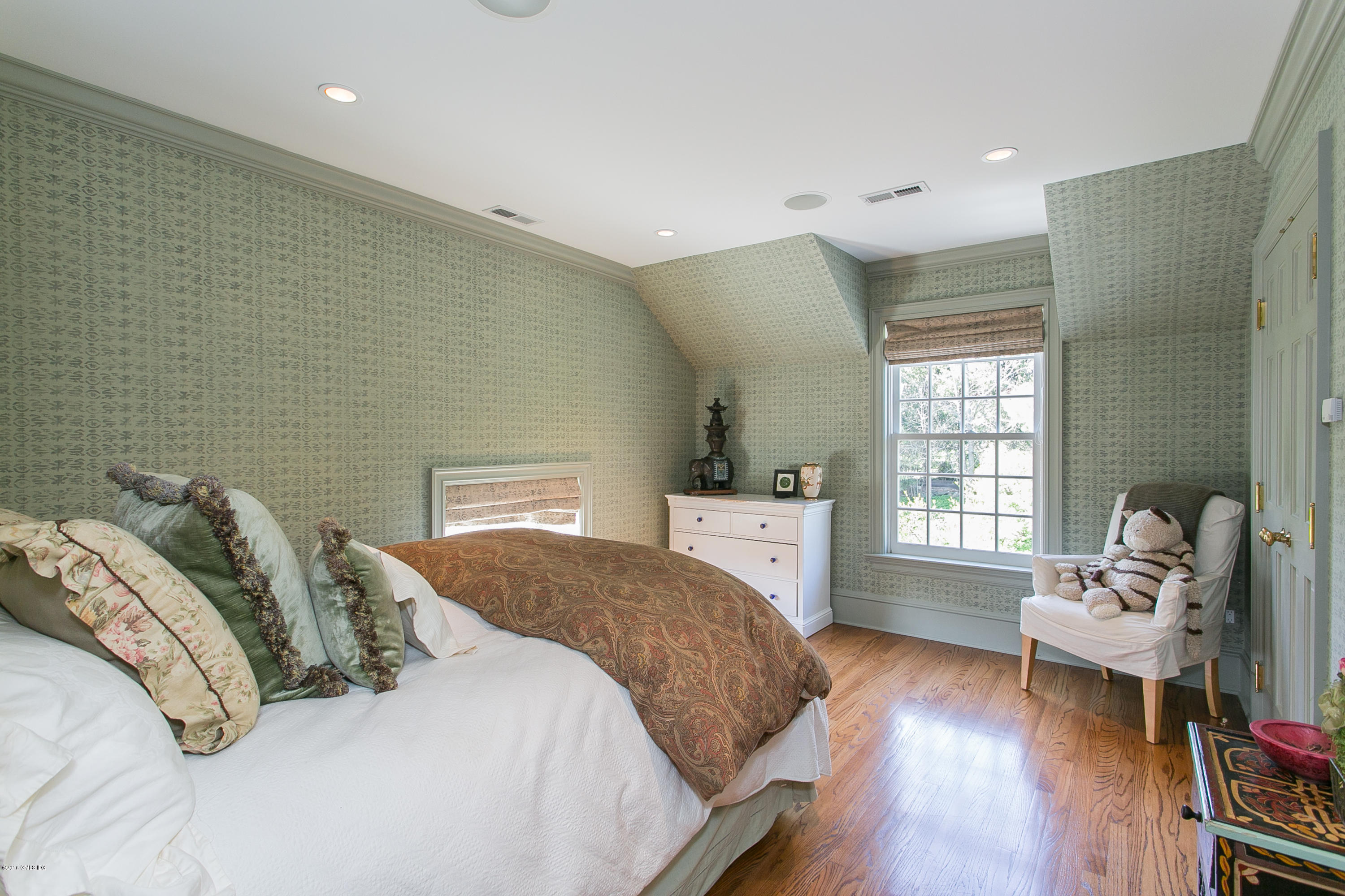 449 Round Hill Road Greenwich, CT 06831 - Photo 42 of 57 a spacious bedroom with a bed and wooden floor