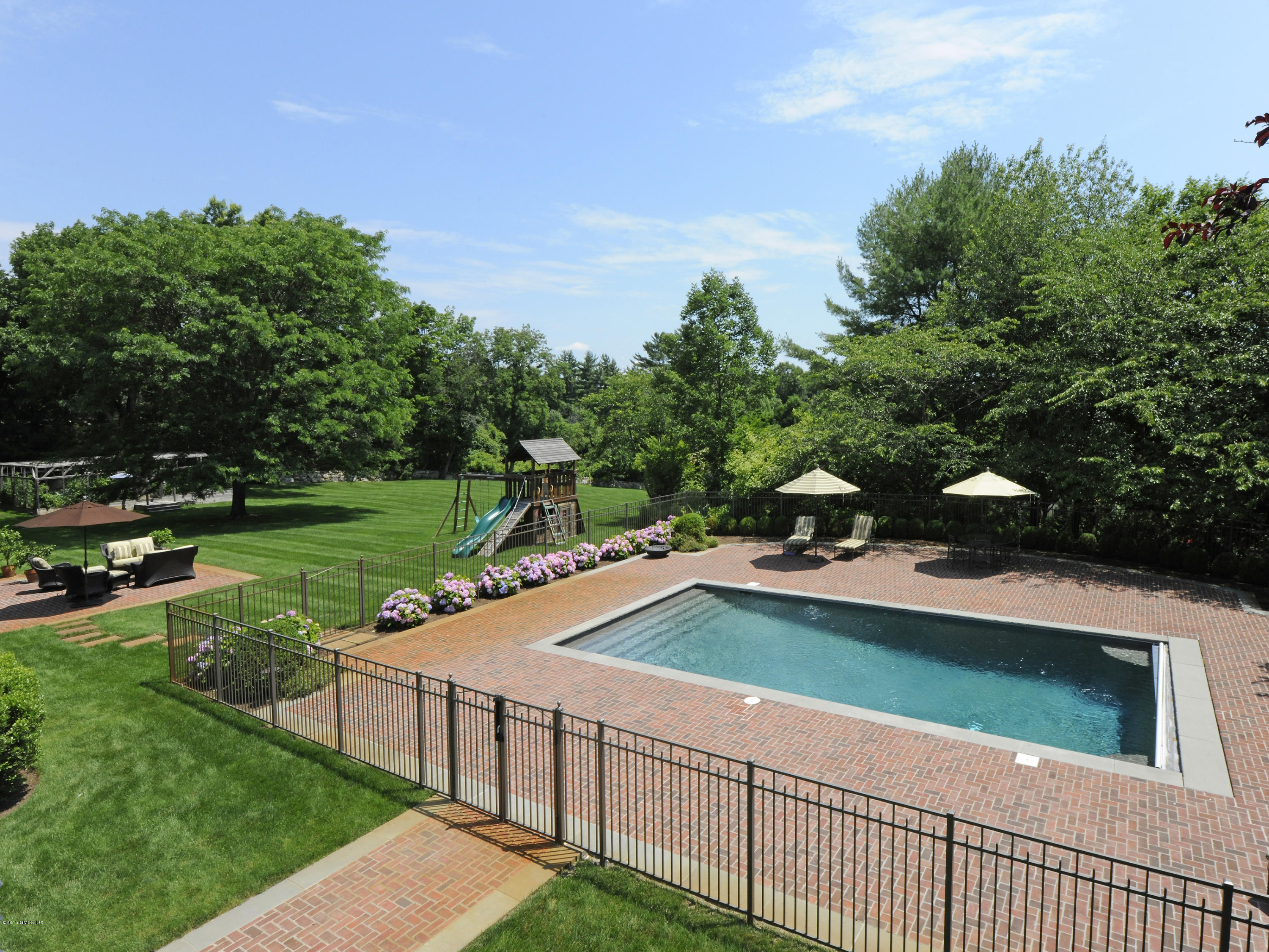 449 Round Hill Road Greenwich, CT 06831 - Photo 49 of 57 a view of a backyard with sitting area