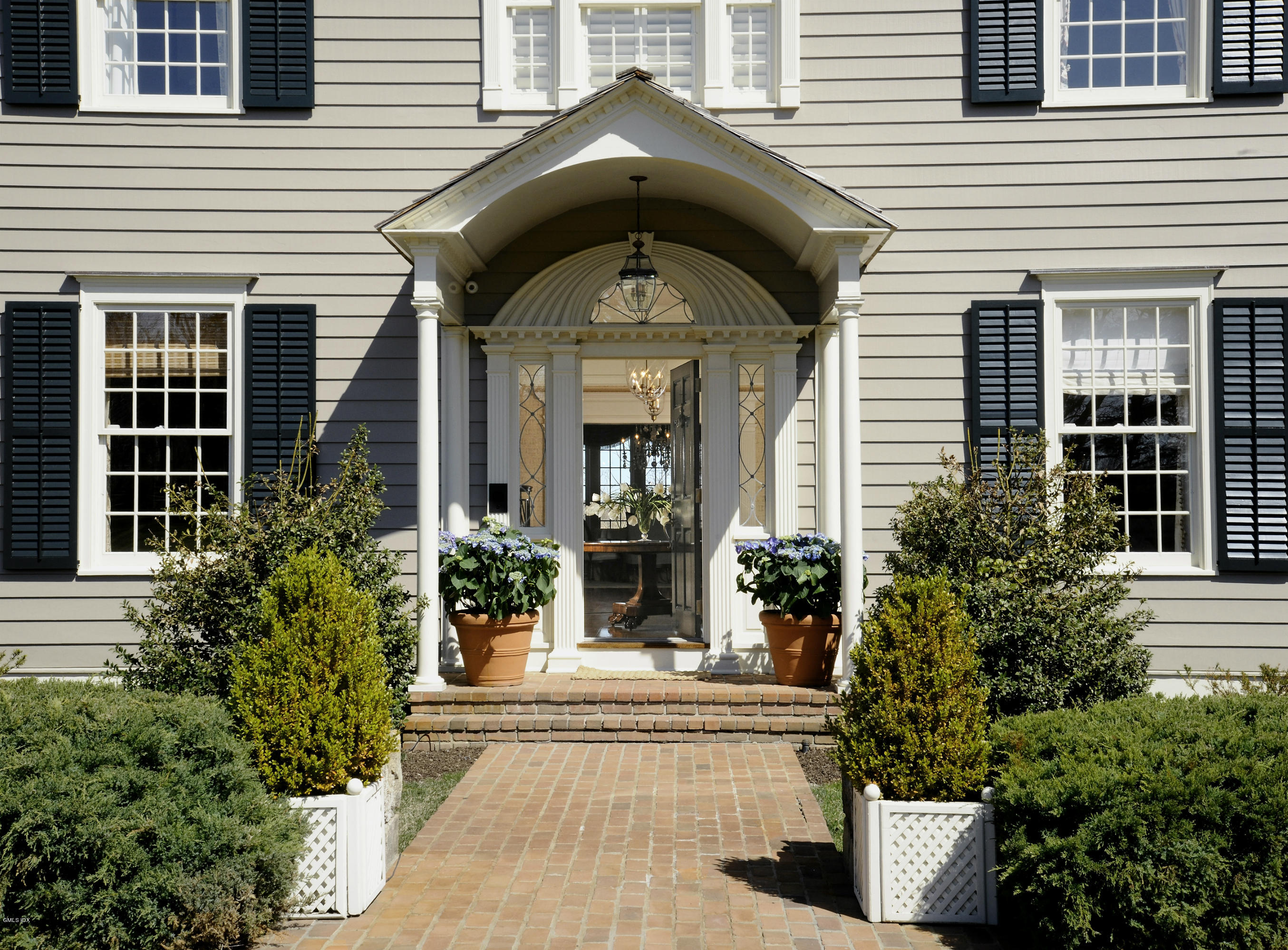 449 Round Hill Road Greenwich, CT 06831 - Photo 5 of 57 a front view of a house with garden