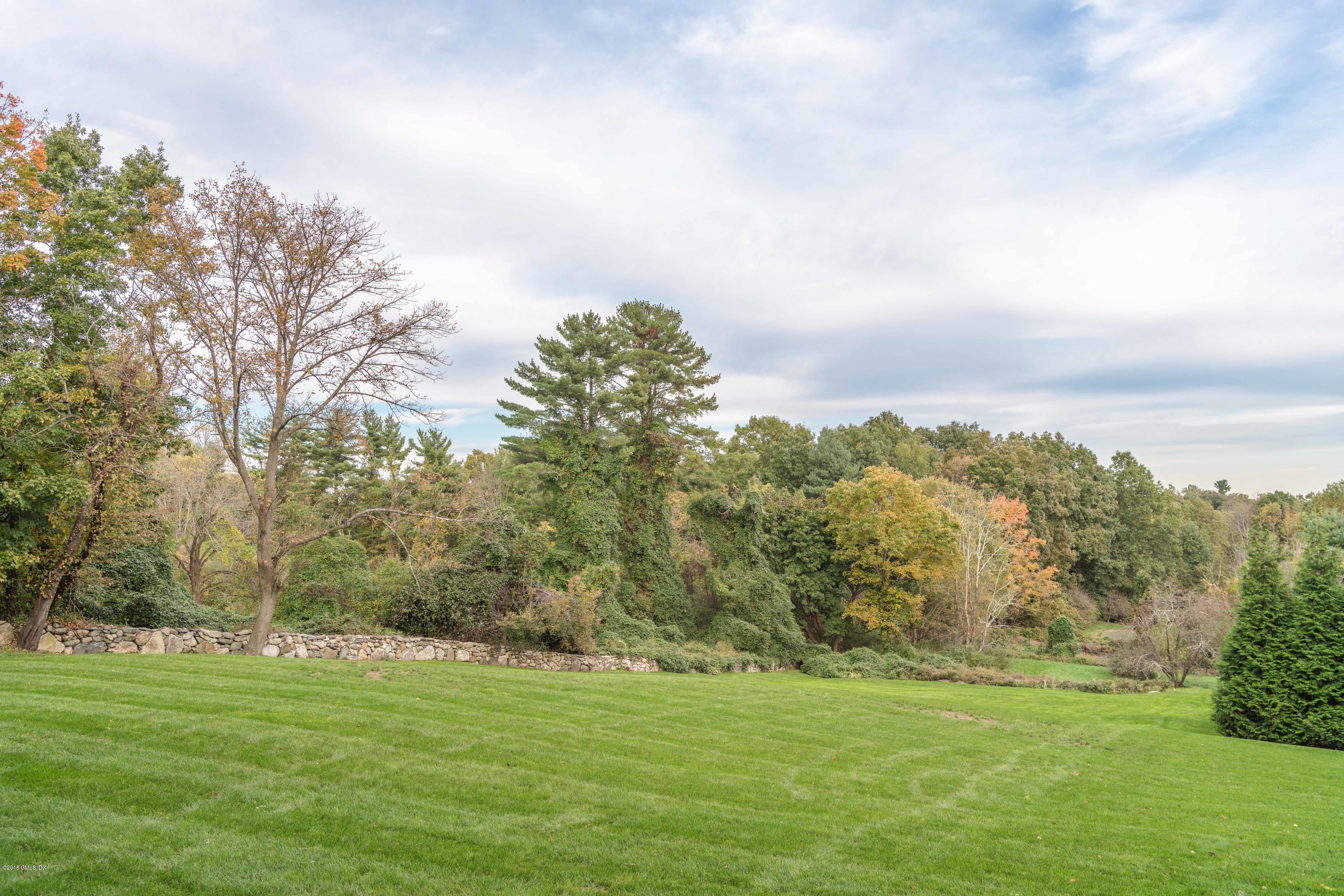449 Round Hill Road Greenwich, CT 06831 - Photo 53 of 57 a backyard of a house with lots of green space