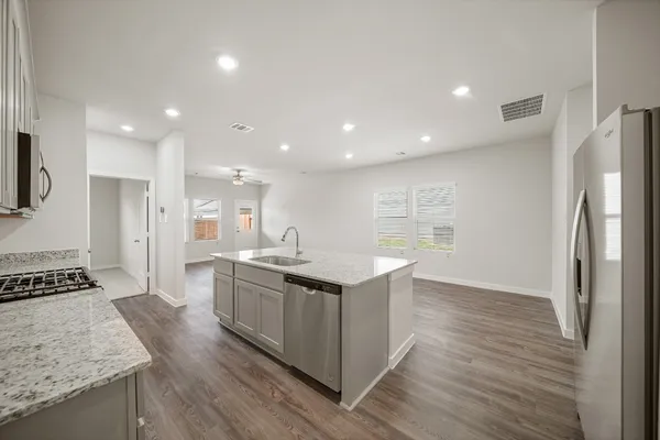 a kitchen with stainless steel appliances granite countertop a stove and a refrigerator