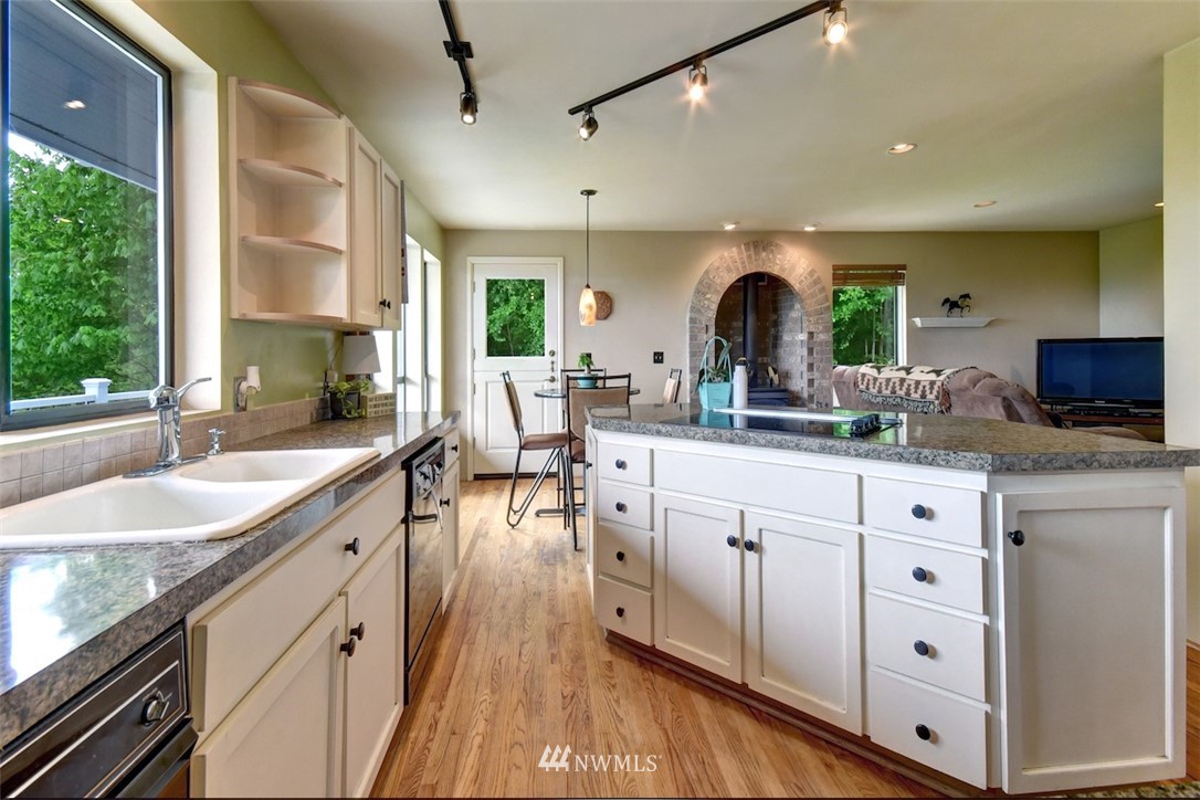 14210 High Bridge Road Snohomish, WA 98296 - Photo 14 of 38 a kitchen with sink cabinets and living room