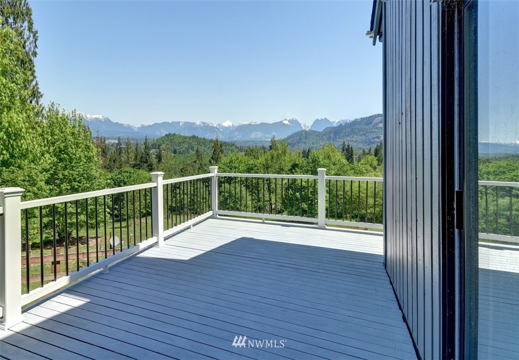 14210 High Bridge Road Snohomish, WA 98296 - Photo 8 of 38 a view of a balcony with wooden floor and fence