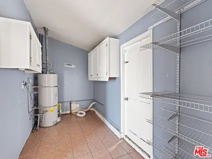 a view of a kitchen with refrigerator and a stove