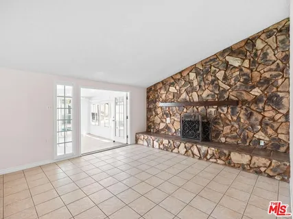 a spacious bedroom with a bed and a window