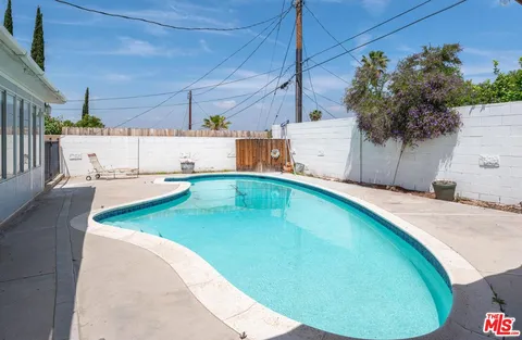 a view of a swimming pool with a patio
