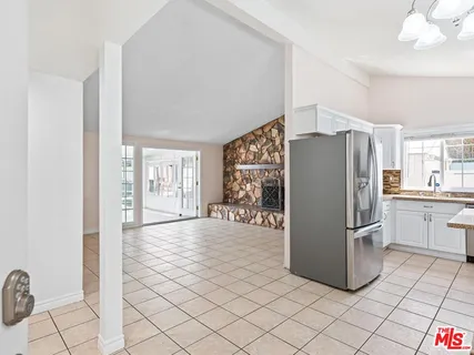 a kitchen with stainless steel appliances a refrigerator and a stove top oven