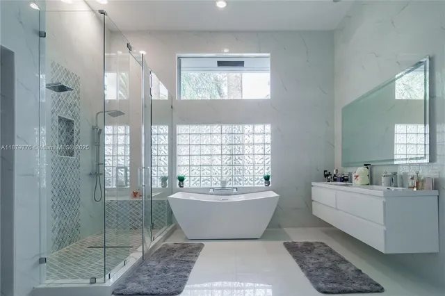 a bathroom with a glass door shower and sink