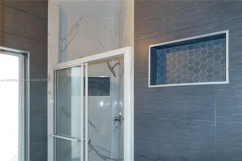 a bathroom with a tub and shower