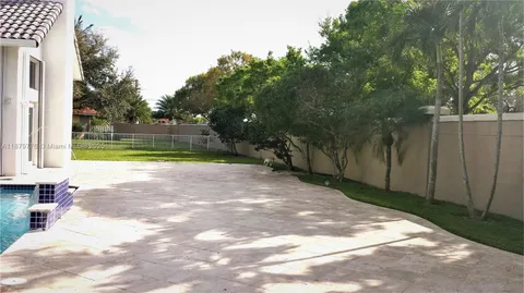 a view of yard with swimming pool and green space