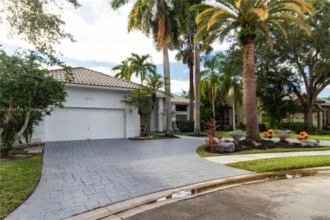a row of palm trees in front of a house