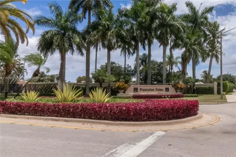 a house with palm tree in front of it