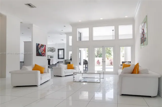 a living room with fireplace furniture and floor to ceiling window