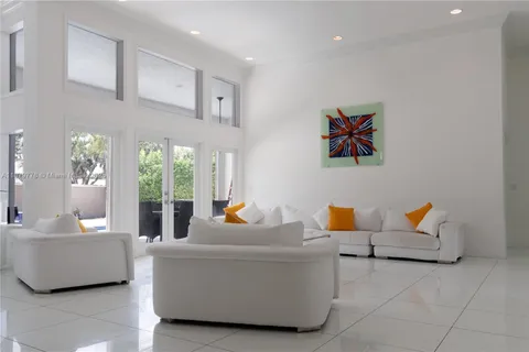 a dining room with furniture and a window