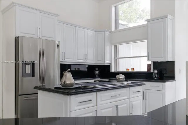 a living room with furniture a fireplace and a chandelier