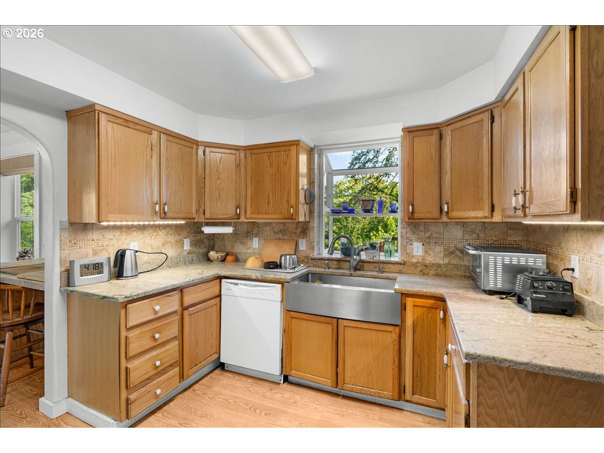 772 Division Street Oregon City, OR 97045 - Photo 8 of 47 a kitchen with stainless steel appliances granite countertop a sink stove and cabinets