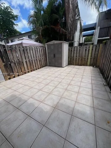 a kitchen with a refrigerator a stove top oven and cabinets