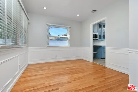 a living room with furniture a potted plant and a large window