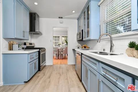 a kitchen with a sink stove top oven and microwave