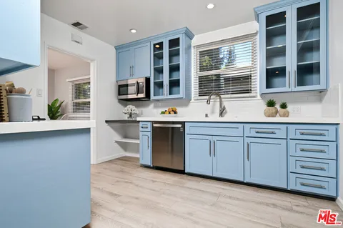 a kitchen with stainless steel appliances granite countertop a stove and a sink