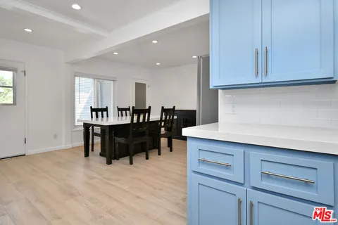 a kitchen with a table and refrigerator