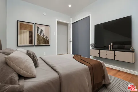 a bedroom with a bed and a large window