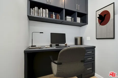 a bed sitting in a spacious bedroom next to a window