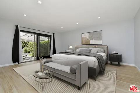 a spacious bedroom with a large bed and a large window
