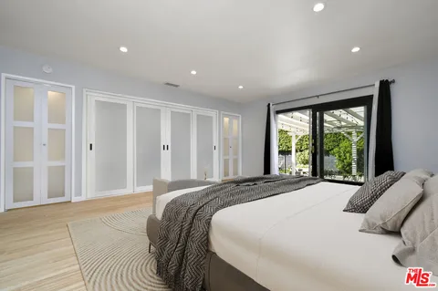 a bedroom with a bed and a walk in closet