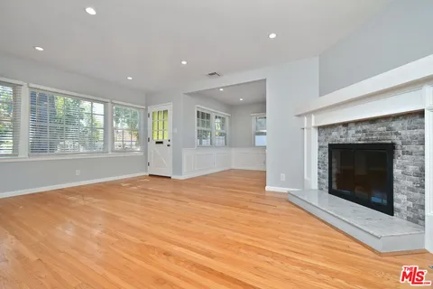 a view of a dining room with furniture wooden floor and a potted plant